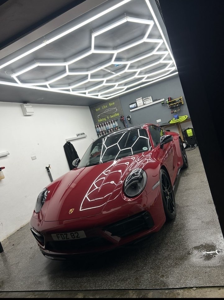 Red Porsche detailing result under studio lights
